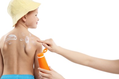 Photo of Mother applying sun protection cream onto her son's skin on white background, closeup