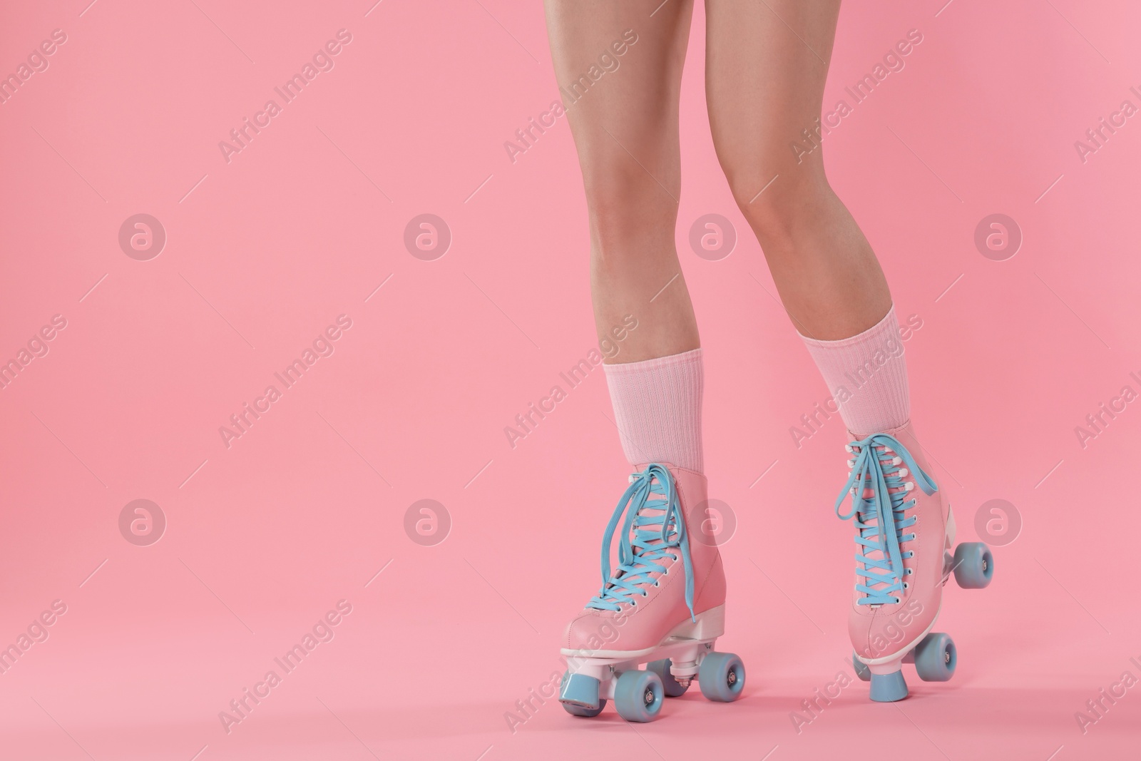 Woman in roller skates on pink background, closeup. Space for text Photo of Woman in roller skates on pink background, closeup. Space for text