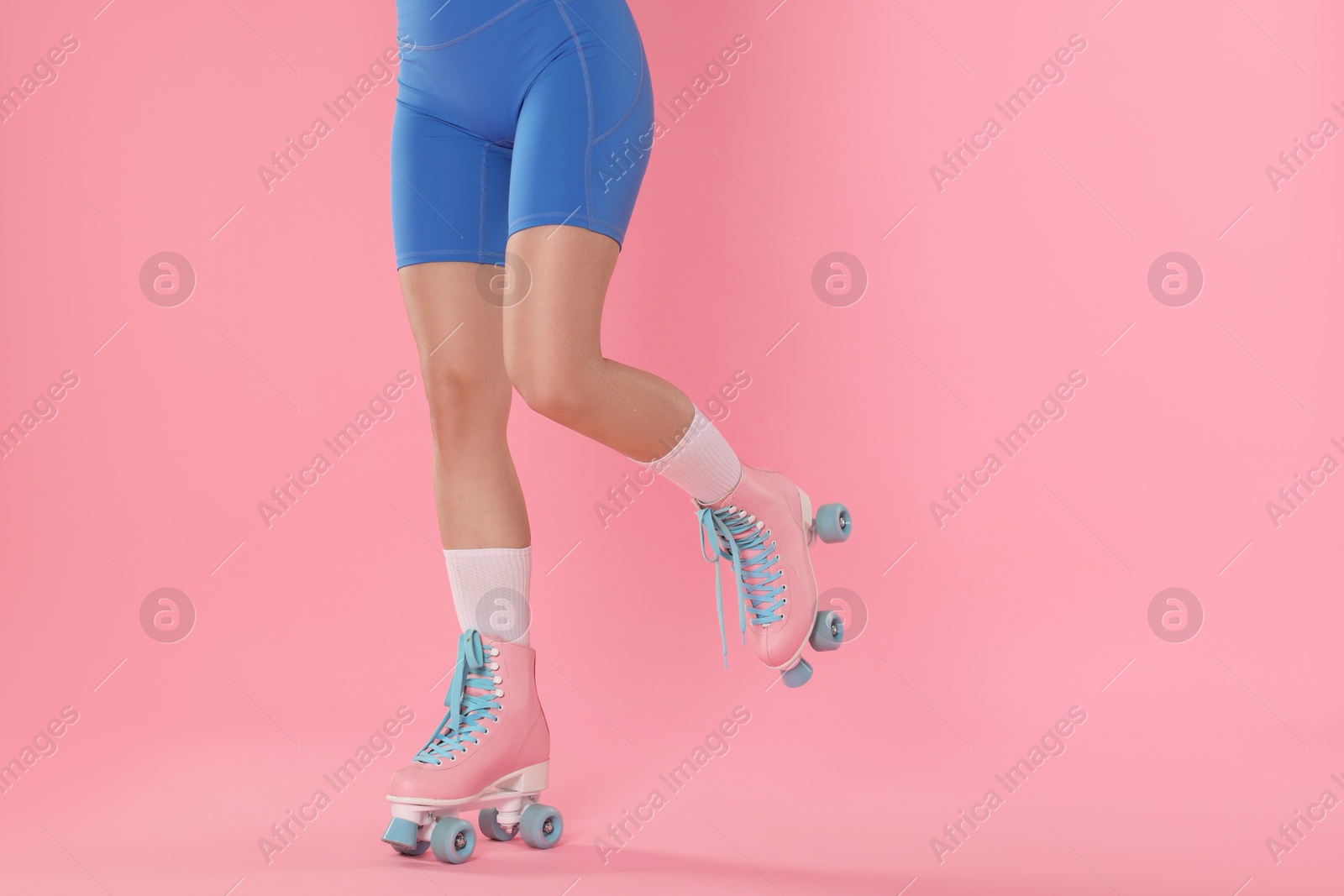 Woman in roller skates on pink background, closeup. Space for text Photo of Woman in roller skates on pink background, closeup. Space for text