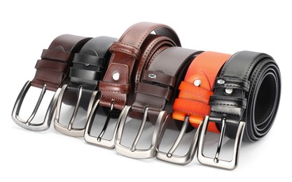 Photo of Many different leather belts isolated on white