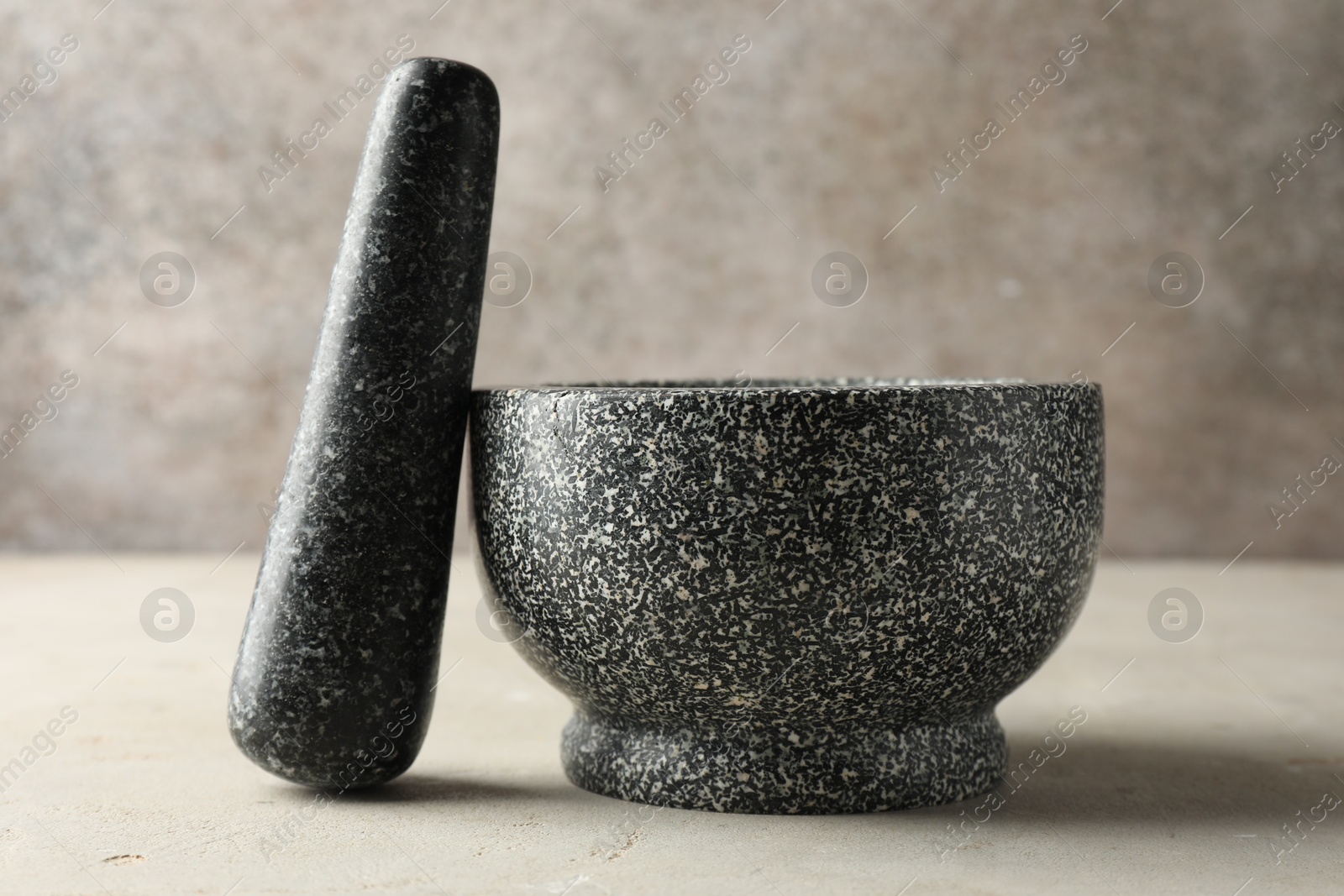 Stone mortar and pestle on light table, closeup Photo of Stone mortar and pestle on light table, closeup