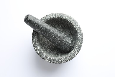 Photo of Stone mortar and pestle on white background, top view
