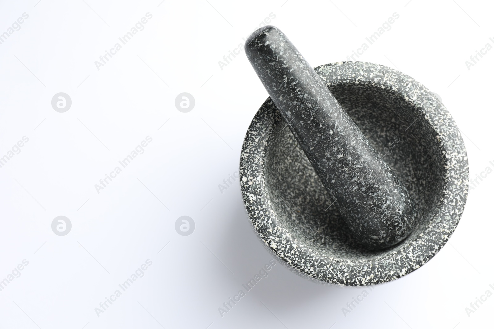 Stone mortar and pestle on white background, top view. Space for text Photo of Stone mortar and pestle on white background, top view. Space for text