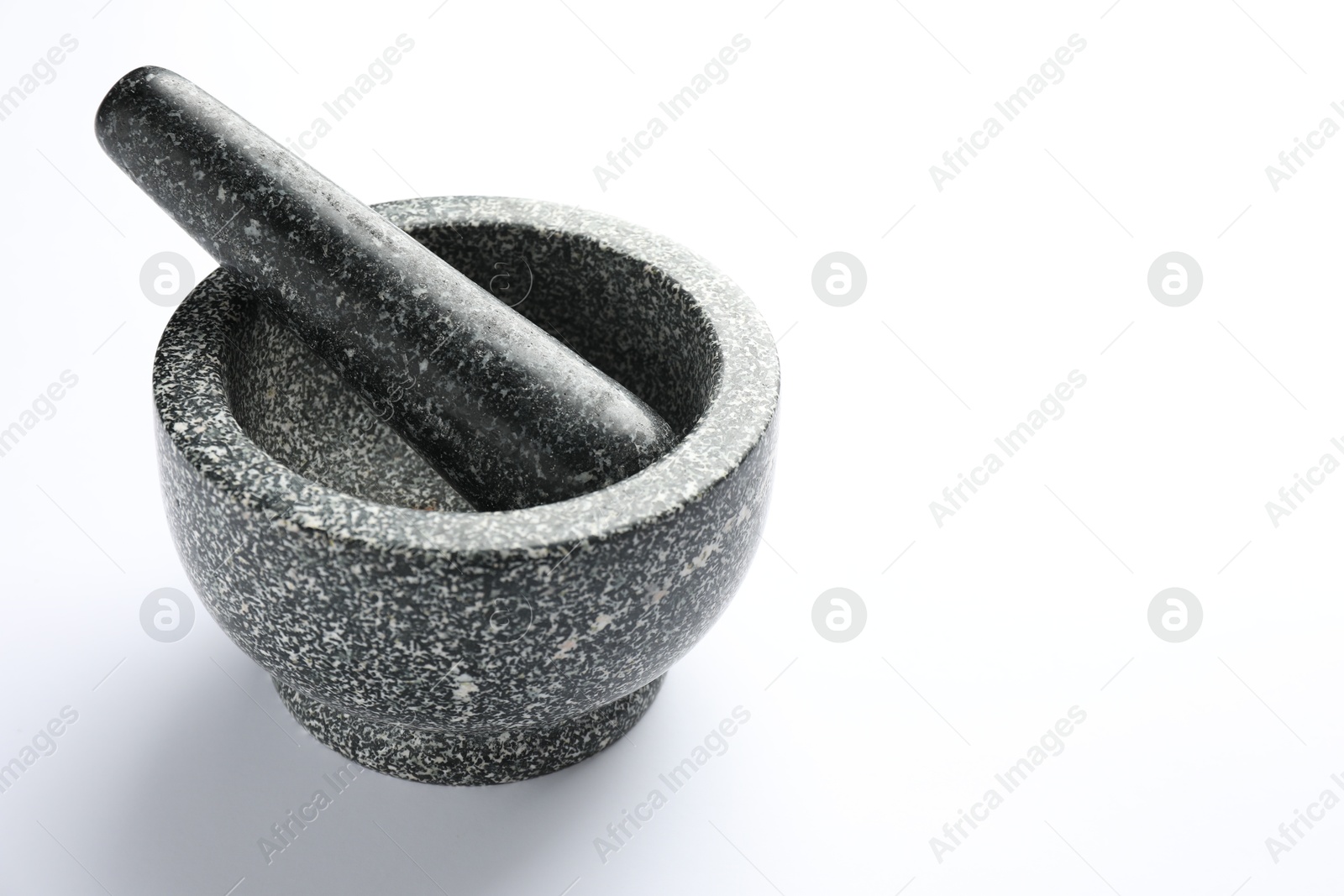 Stone mortar and pestle on white background, space for text Photo of Stone mortar and pestle on white background, space for text
