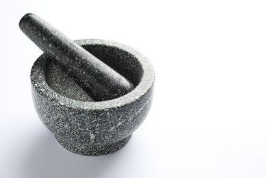 Photo of Stone mortar and pestle on white background, space for text