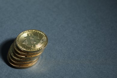 Photo of Cryptocurrency. Golden bitcoins on grey background, closeup. Space for text