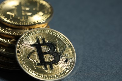 Photo of Cryptocurrency. Golden bitcoins on grey background, closeup. Space for text