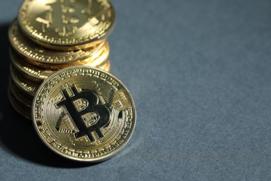 Photo of Cryptocurrency. Golden bitcoins on grey background, closeup. Space for text