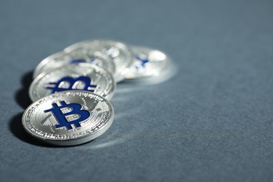 Photo of Cryptocurrency. Silver bitcoins on grey background, closeup. Space for text