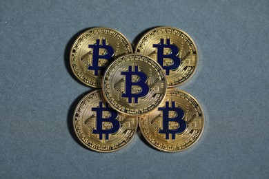 Photo of Cryptocurrency. Golden bitcoins on grey background, flat lay