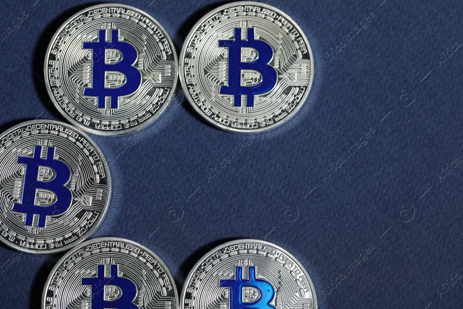 Cryptocurrency. Silver bitcoins on dark blue background, flat lay. Space for text Photo of Cryptocurrency. Silver bitcoins on dark blue background, flat lay. Space for text