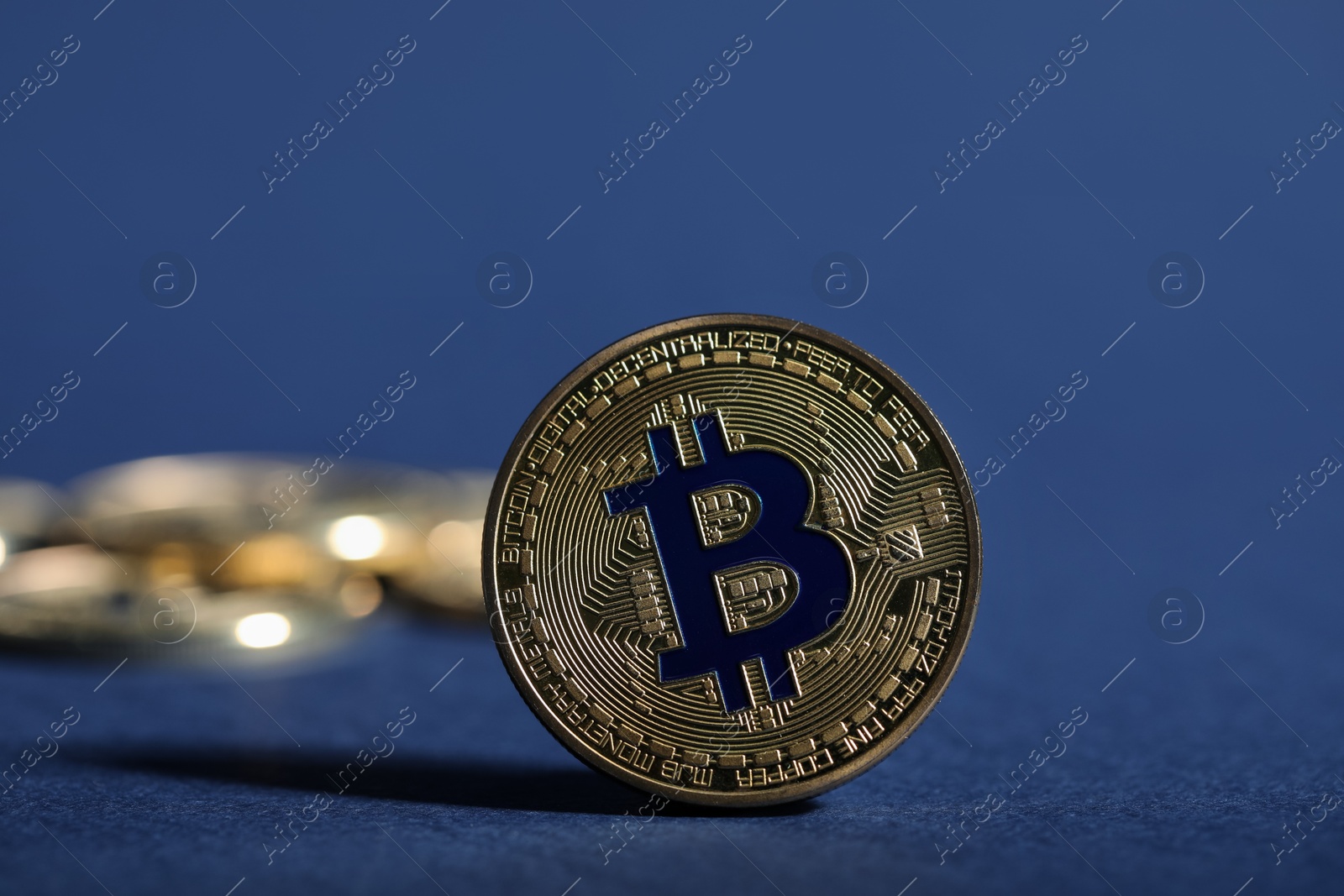 Cryptocurrency. Golden bitcoins on dark blue background, closeup Photo of Cryptocurrency. Golden bitcoins on dark blue background, closeup