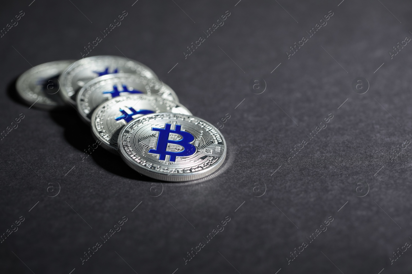 Cryptocurrency. Silver bitcoins on grey background, closeup. Space for text Photo of Cryptocurrency. Silver bitcoins on grey background, closeup. Space for text