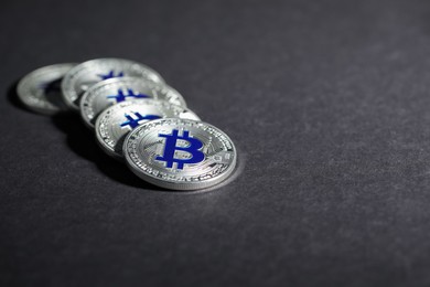 Photo of Cryptocurrency. Silver bitcoins on grey background, closeup. Space for text
