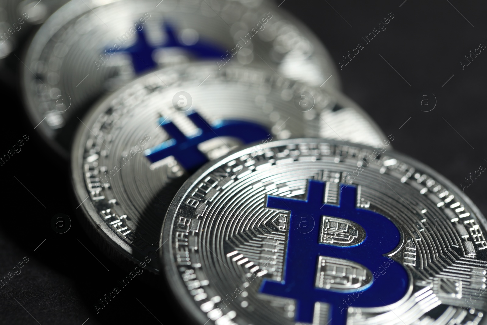 Cryptocurrency. Silver bitcoins on grey background, closeup Photo of Cryptocurrency. Silver bitcoins on grey background, closeup