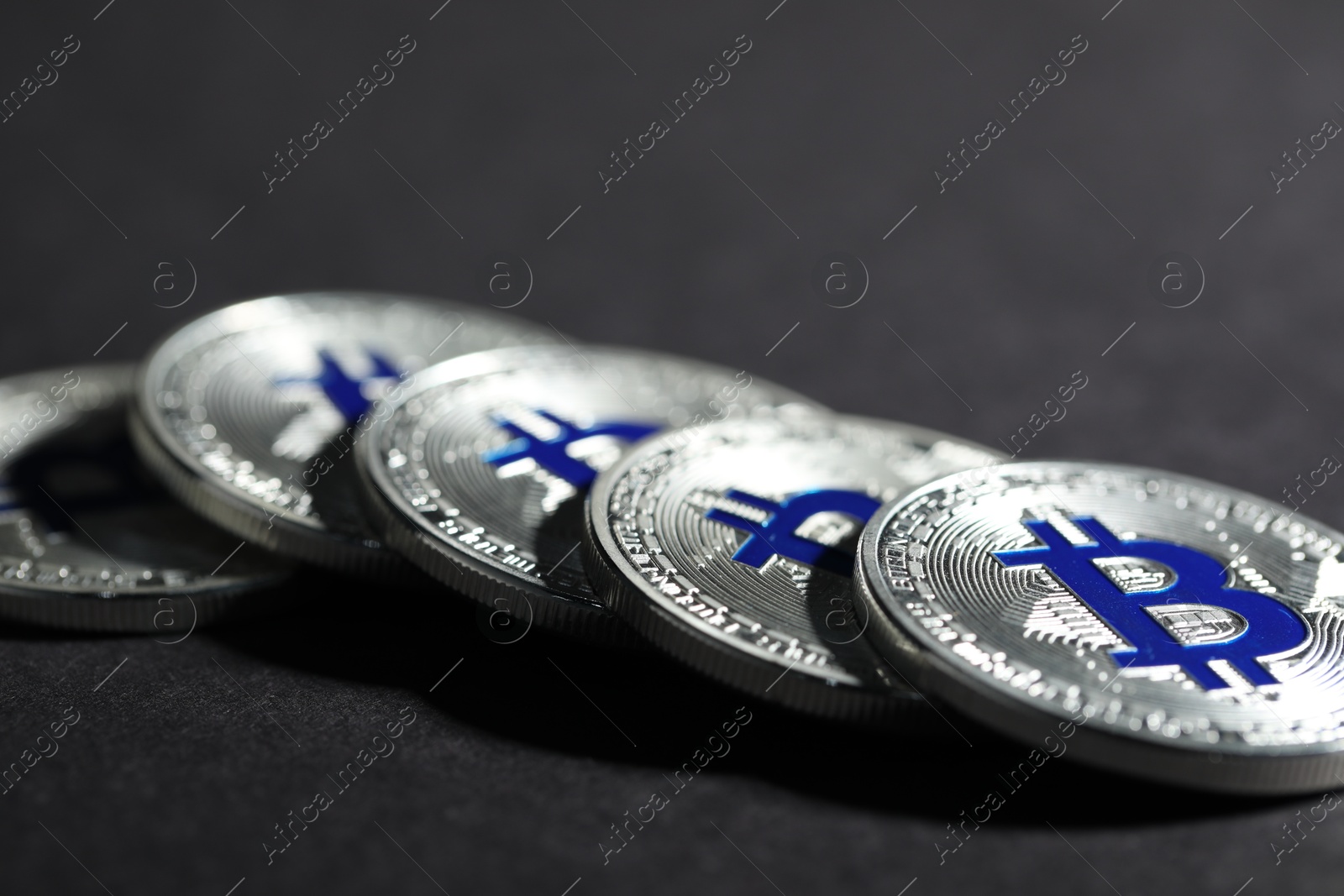 Cryptocurrency. Silver bitcoins on grey background, closeup Photo of Cryptocurrency. Silver bitcoins on grey background, closeup