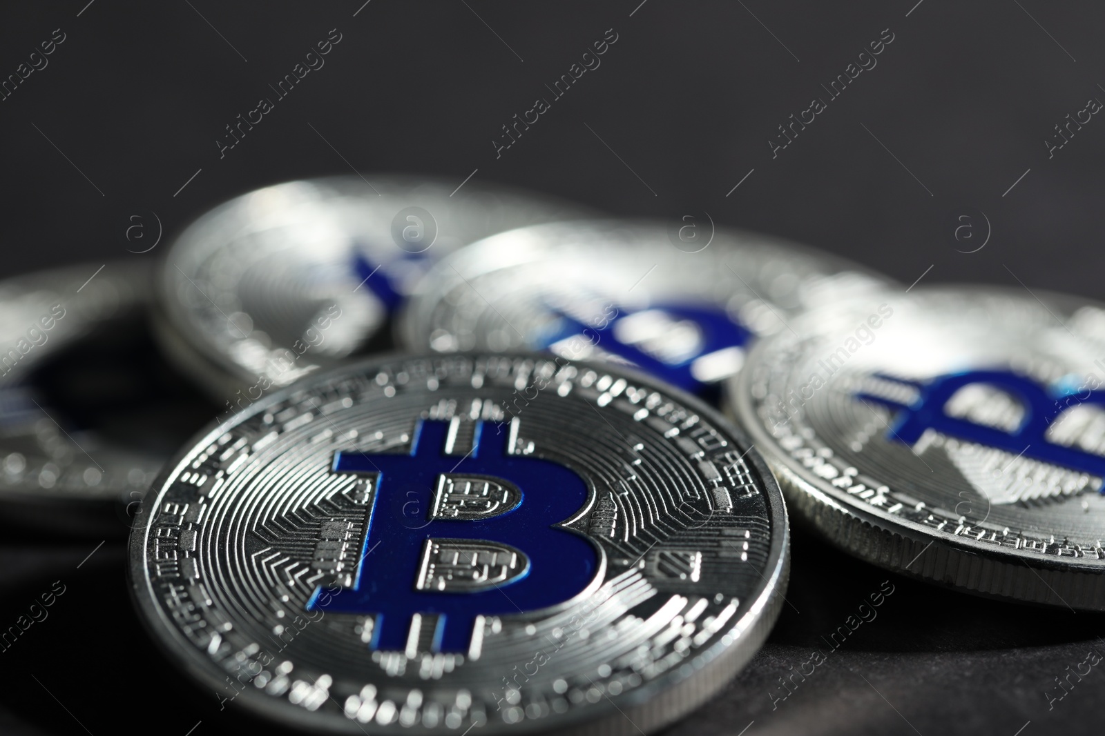 Cryptocurrency. Silver bitcoins on grey background, closeup Photo of Cryptocurrency. Silver bitcoins on grey background, closeup