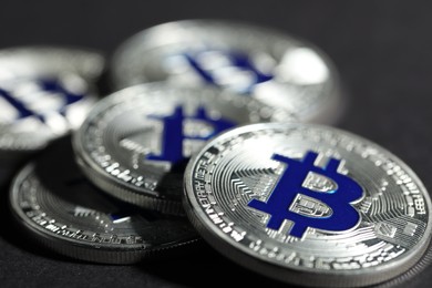 Photo of Cryptocurrency. Silver bitcoins on grey background, closeup