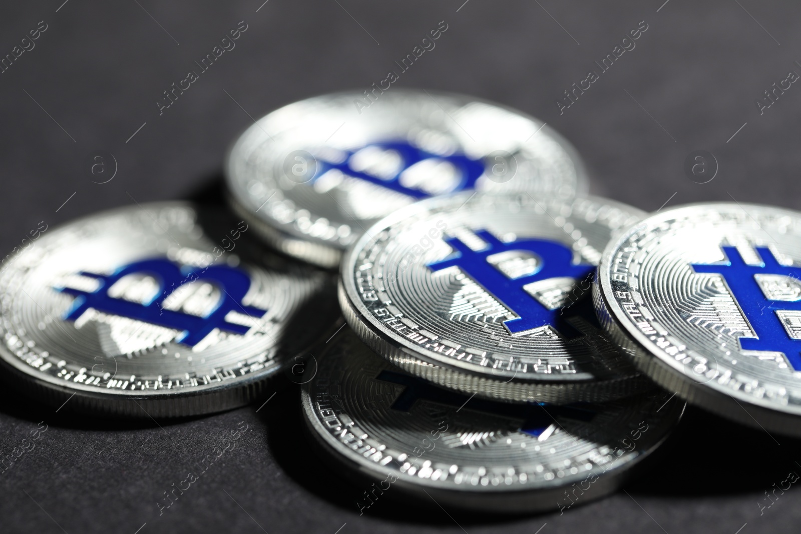 Cryptocurrency. Silver bitcoins on grey background, closeup Photo of Cryptocurrency. Silver bitcoins on grey background, closeup