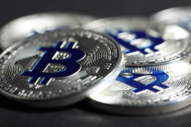 Photo of Cryptocurrency. Silver bitcoins on grey background, closeup