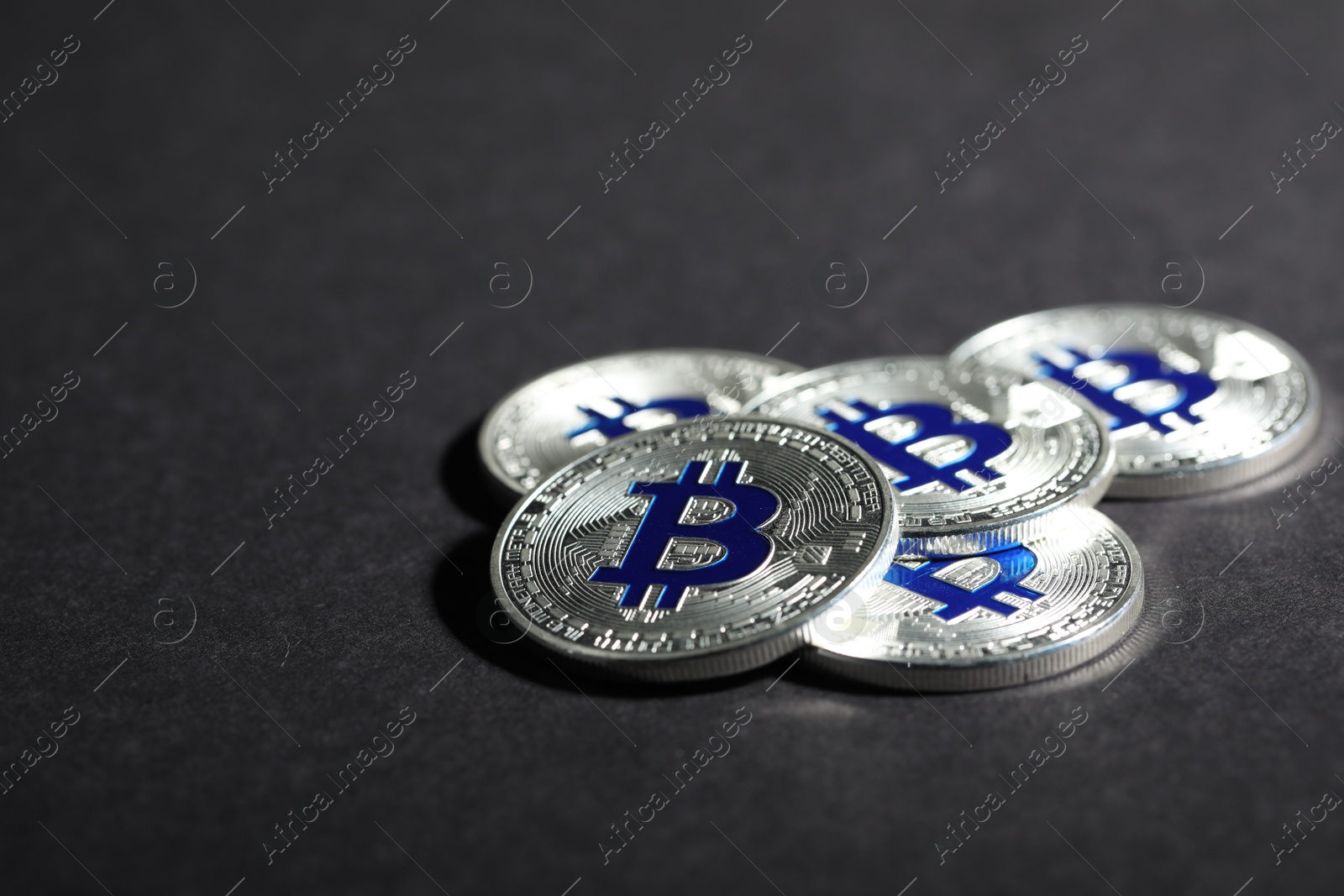 Cryptocurrency. Silver bitcoins on grey background, closeup Photo of Cryptocurrency. Silver bitcoins on grey background, closeup