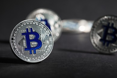 Photo of Cryptocurrency. Silver bitcoins on grey background, closeup