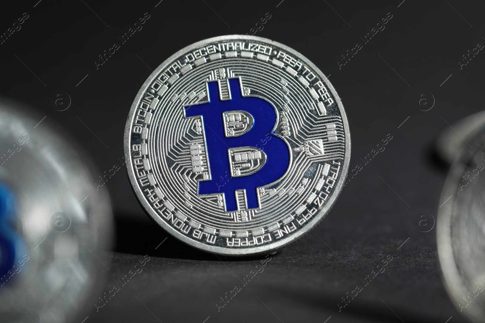 Cryptocurrency. Silver bitcoins on grey background, closeup Photo of Cryptocurrency. Silver bitcoins on grey background, closeup