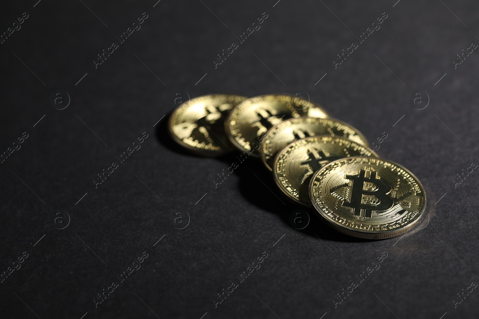 Cryptocurrency. Golden bitcoins on grey background, closeup Photo of Cryptocurrency. Golden bitcoins on grey background, closeup