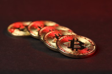 Photo of Cryptocurrency. Golden bitcoins on dark background, closeup