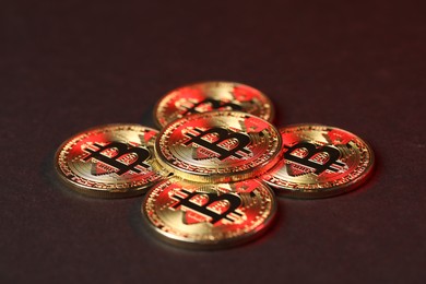 Photo of Cryptocurrency. Golden bitcoins on dark background, closeup