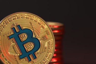 Photo of Cryptocurrency. Golden bitcoins on dark background, closeup. Space for text