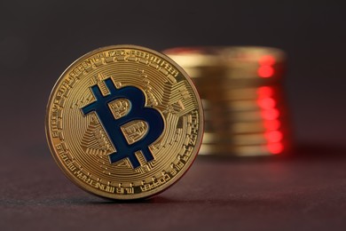 Photo of Cryptocurrency. Golden bitcoins on dark background, closeup