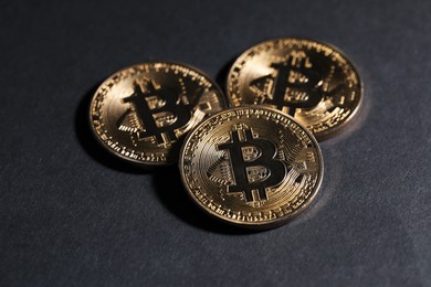 Photo of Cryptocurrency. Golden bitcoins on grey background, closeup