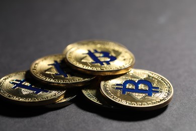 Photo of Cryptocurrency. Golden bitcoins on grey background, closeup