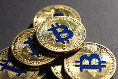 Photo of Cryptocurrency. Golden bitcoins on grey background, closeup