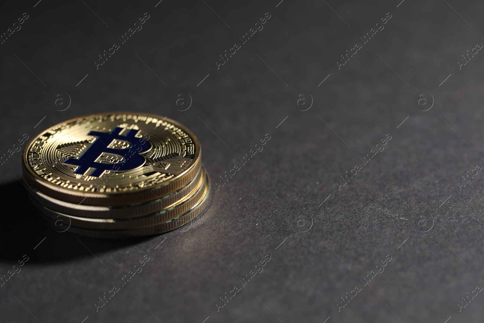 Cryptocurrency. Golden bitcoins on grey background, closeup. Space for text Photo of Cryptocurrency. Golden bitcoins on grey background, closeup. Space for text