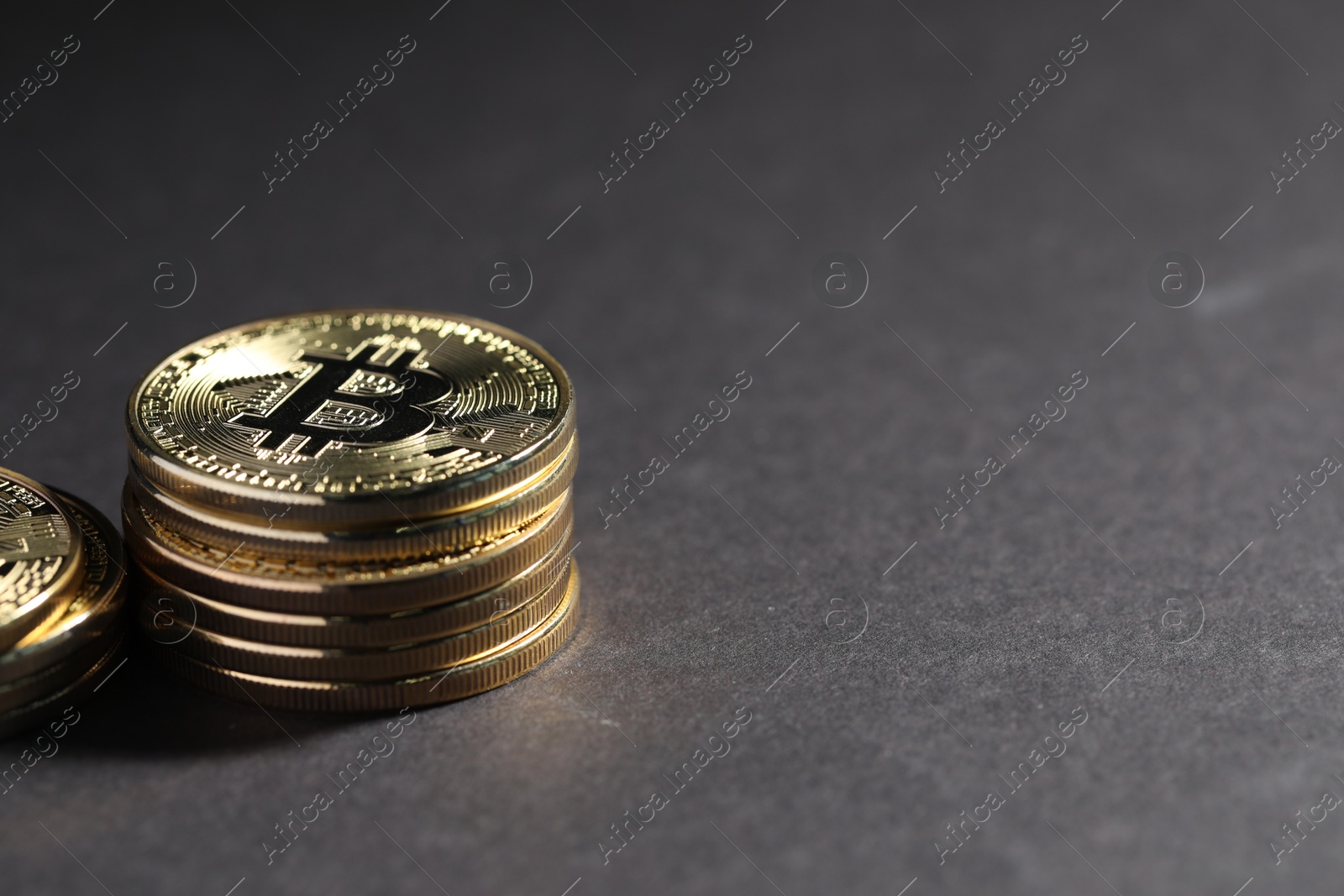 Cryptocurrency. Golden bitcoins on grey background, closeup. Space for text Photo of Cryptocurrency. Golden bitcoins on grey background, closeup. Space for text