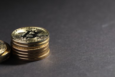 Photo of Cryptocurrency. Golden bitcoins on grey background, closeup. Space for text