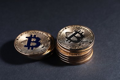 Photo of Cryptocurrency. Golden bitcoins on grey background, closeup