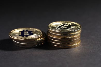 Photo of Cryptocurrency. Golden bitcoins on grey background, closeup