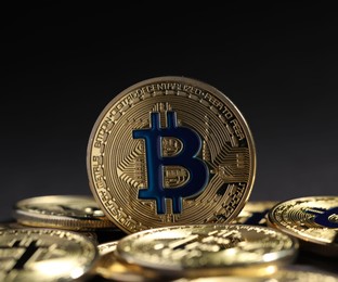 Photo of Cryptocurrency. Golden bitcoins on grey background, closeup