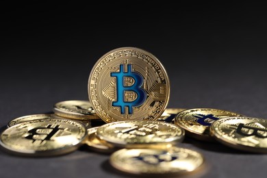 Photo of Cryptocurrency. Golden bitcoins on grey background, closeup