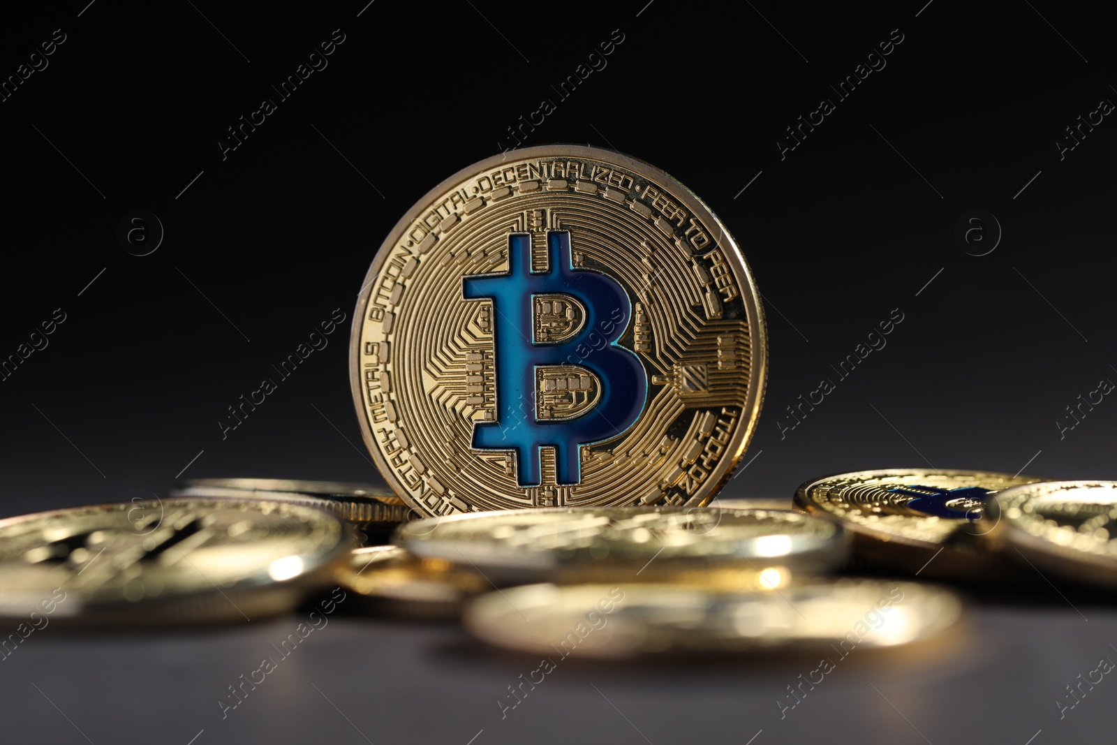 Cryptocurrency. Golden bitcoins on grey background, closeup Photo of Cryptocurrency. Golden bitcoins on grey background, closeup