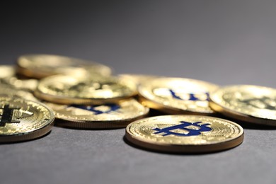 Photo of Cryptocurrency. Golden bitcoins on grey background, closeup