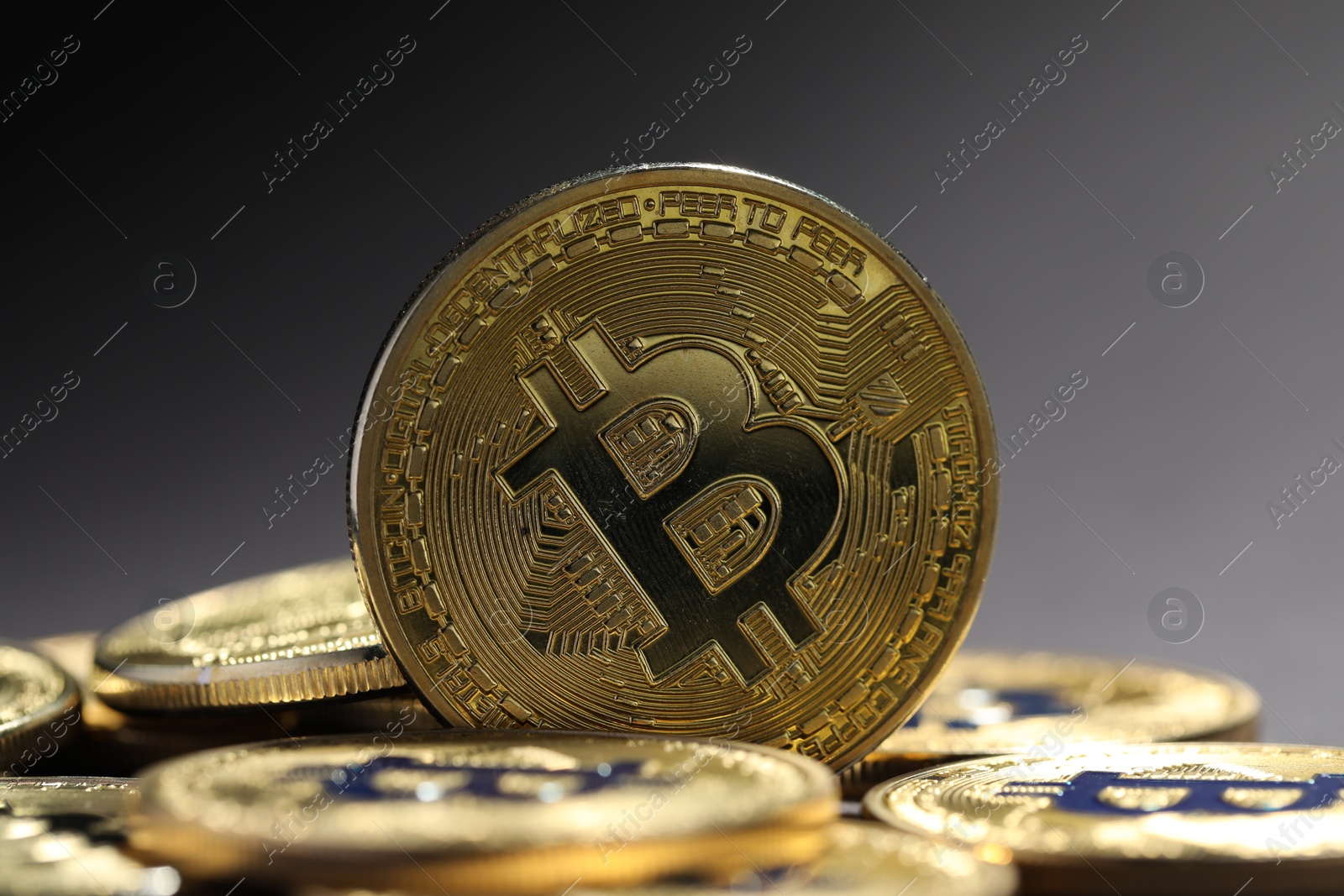 Cryptocurrency. Golden bitcoins on grey background, closeup Photo of Cryptocurrency. Golden bitcoins on grey background, closeup