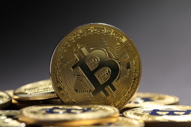 Photo of Cryptocurrency. Golden bitcoins on grey background, closeup