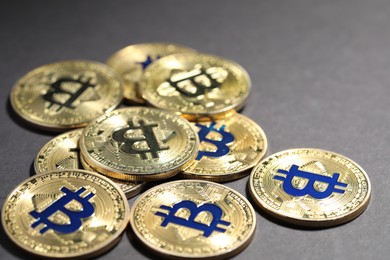Photo of Cryptocurrency. Golden bitcoins on grey background, closeup