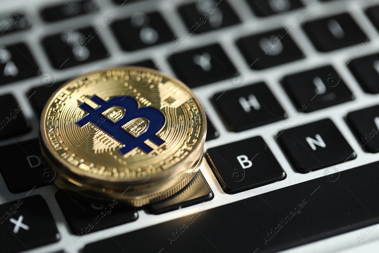 Cryptocurrency. Golden bitcoins on laptop, closeup. Space for text Photo of Cryptocurrency. Golden bitcoins on laptop, closeup. Space for text