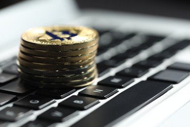 Photo of Cryptocurrency. Golden bitcoins on laptop, closeup. Space for text