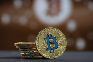 Photo of Cryptocurrency. Golden bitcoins on grey table, closeup